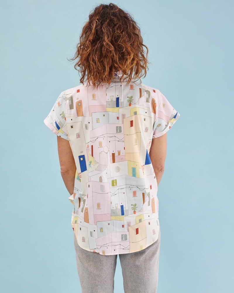 Camisa illán estampado Fachadas con corte suelto, cuello amplio y manga corta japonesa. Bajo ligeramente asimétrico. 100% algodón satinado. Hecha en España