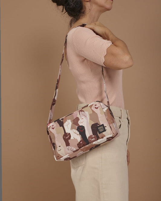 Bolso bandolera con asa regulable y compartimentos interiores. Estampado con un diseño de manos en alza de pieles de todos los tonos, moda lentita, moda española, moda femenina