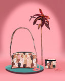  Bolso bandolera con asa regulable y compartimentos interiores. Estampado con un diseño de manos en alza de pieles de todos los tonos, moda lentita, moda española, moda femenina